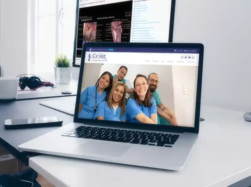laptop with a picture of a site with people