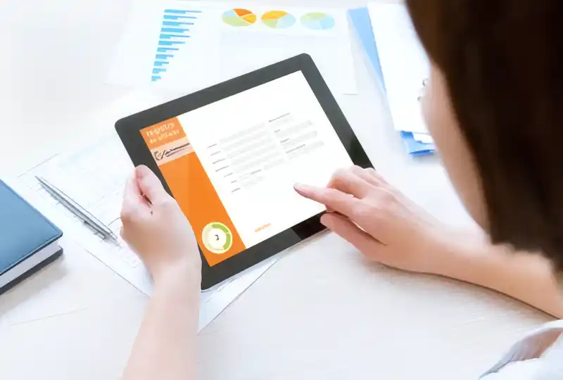 person holding a tablet with a dashboard